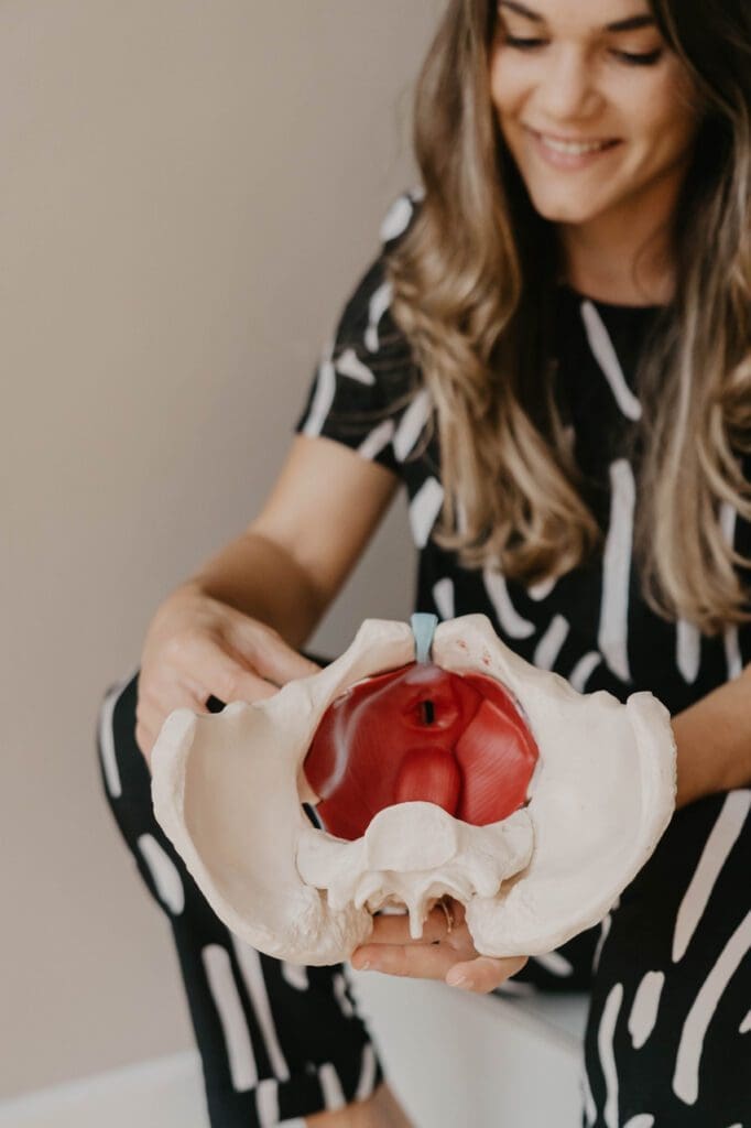 Image of a Woman Holding Pelvic Skeleton